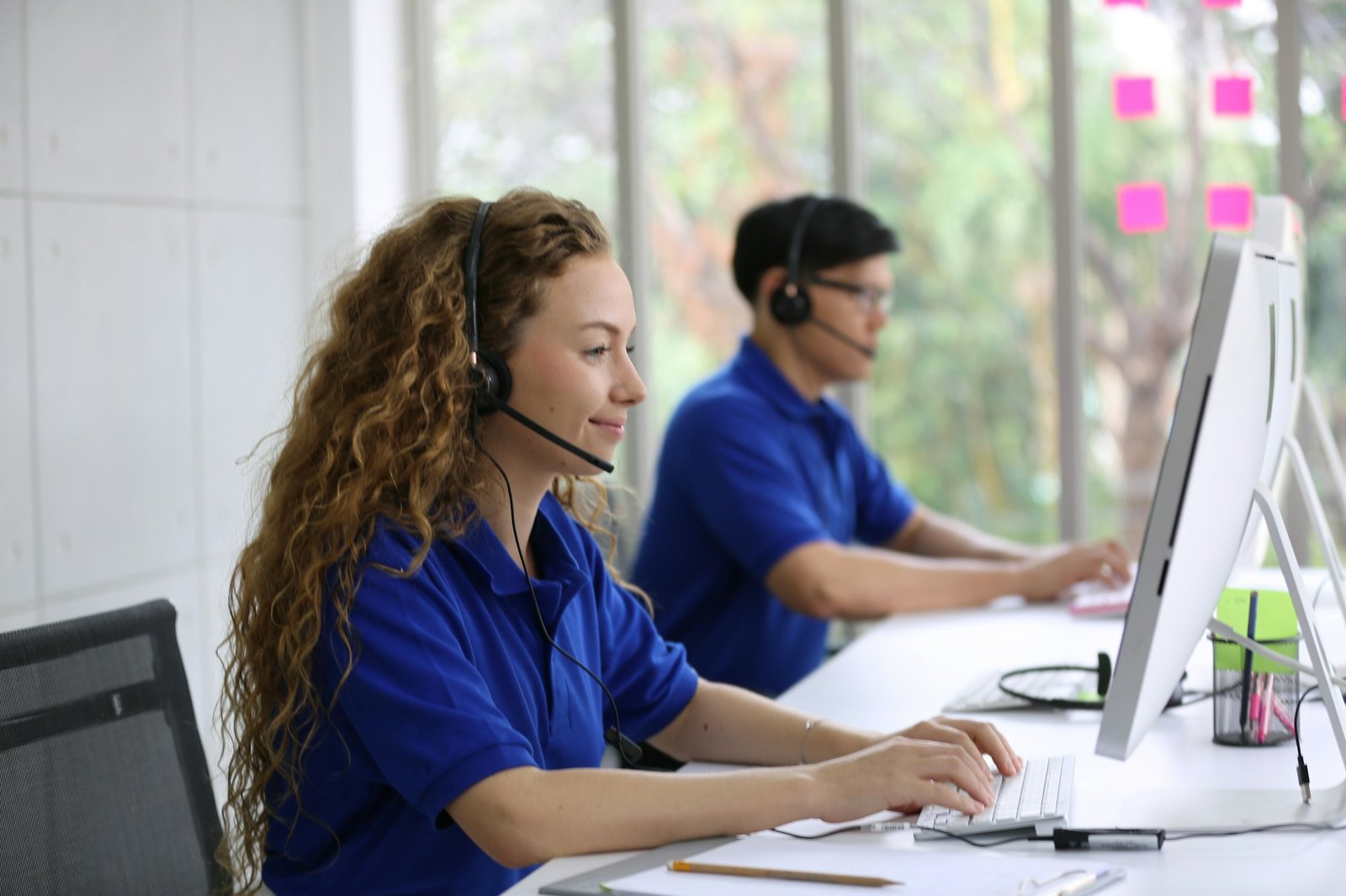 Smiling Woman In Headset Working In Call Center Office